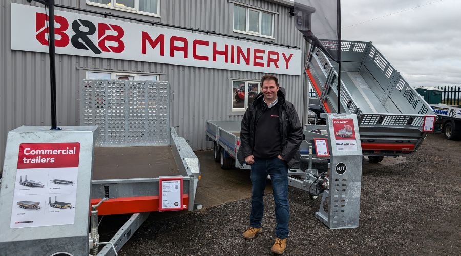 BJT’s business development manager Jim Cherry  standing with two trailers in front of B&B Machinery depot