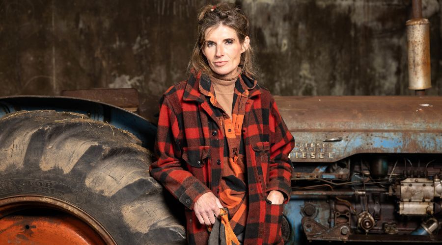 Amanda Owen, Yorkshire shepherdess, standing in front of a tractor