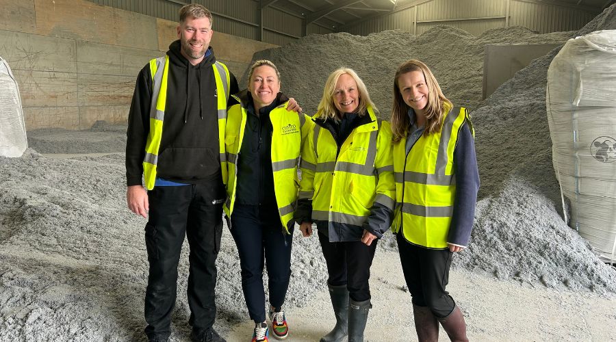 left to right: Geoff Wilson, Steph Bedford, Liz Russell and Sally Russell - the leadership team at EnviroSystems in front of EnviroBed paper-based cow bedding. 
