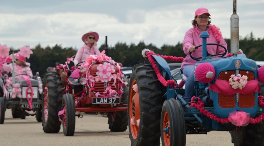 three tractors decorated in pink